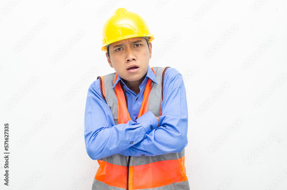 stressed over work concept illustrated by asian male construction worker in blue shirt, orange vest and yellow safety helmet with furious, mad, sad, angry expression. overworked concept stressed over work concept illustrated by asian male construction worker in blue shirt, orange vest and yellow safety helmet with furious, mad, sad, angry expression. overworked concept