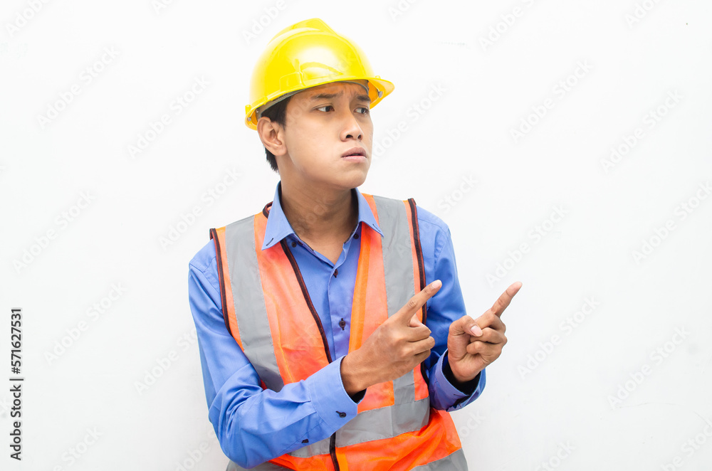 stressed over work concept illustrated by asian male construction worker in blue shirt, orange vest and yellow safety helmet with furious, mad, sad, angry expression. overworked concept stressed over work concept illustrated by asian male construction worker in blue shirt, orange vest and yellow safety helmet with furious, mad, sad, angry expression. overworked concept