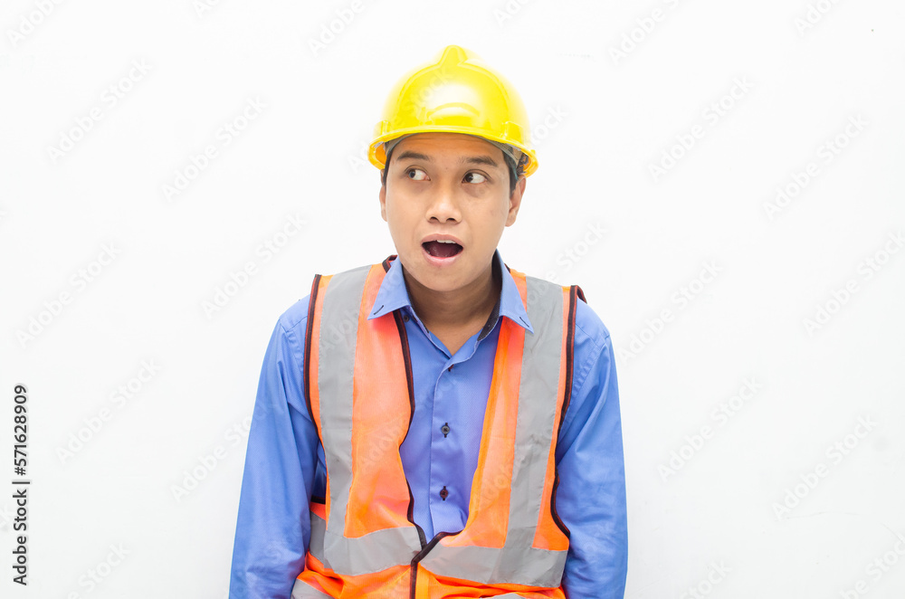 overjoyed asian male construction worker opening mouth shocked and surprised. construction worker with wow expression.