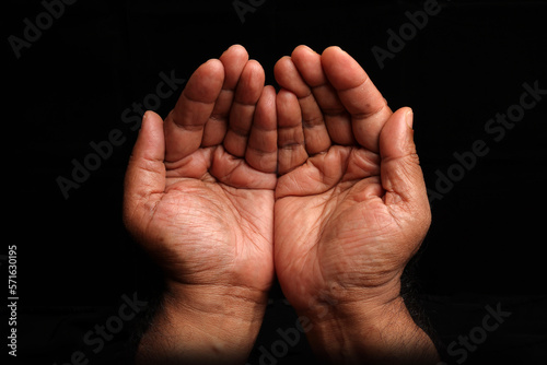 Asian dark skin top view holding five finger palm of hand praying begging asking giving on black background