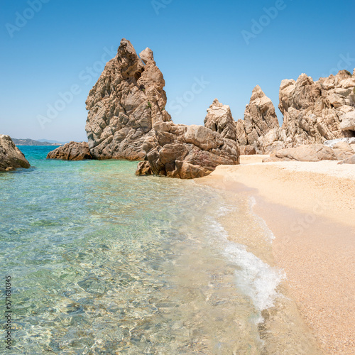 Empty beach with crystal clear sea water and phenomenal rocks. Greece, Halkidiki, Athos peninsula, Trimi beach, Ouranoupolis. Idyllic hidden travel location, romantic vacation, summer holiday