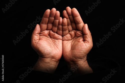 Asian dark skin top view holding five finger palm of hand  praying begging asking giving on black background