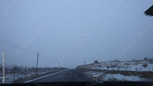 Time lapse of driving a car on a rural road. POV, point of view, time-lapse of countryside driving on a snowy winter day photo