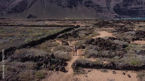 Drone pilot flying drone filming shooting video or taking photos on travel vacation in beautiful nature landscape on Lanzarote. High quality FullHD footage