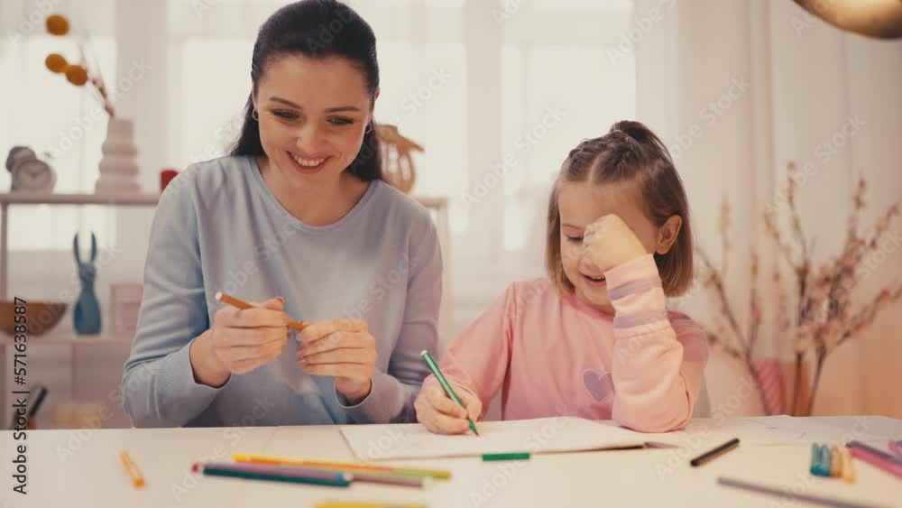 Mother and little daughter drawing together at home, indoor activities Mother and little daughter drawing together at home, indoor activities