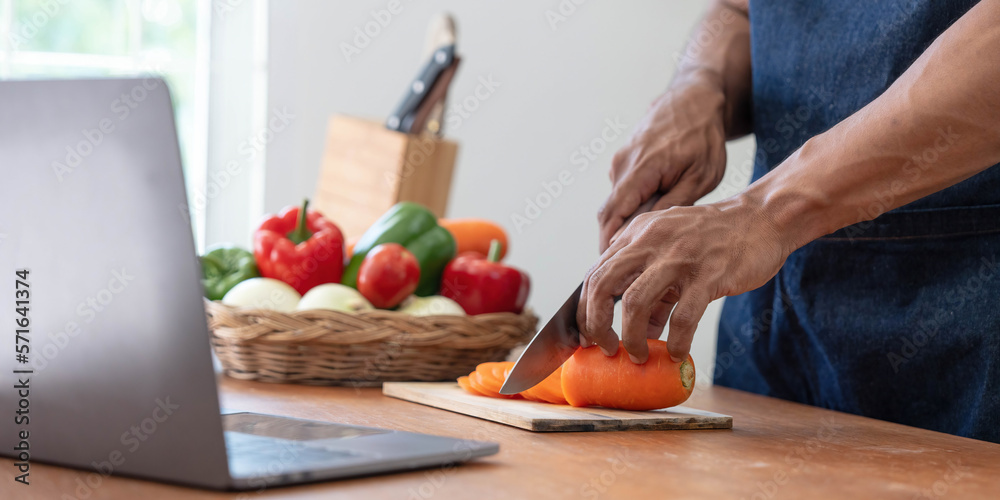 Closeup portrait of asian man making salad at home. cooking food and Lifestyle moment