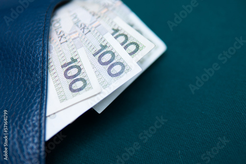 PLN 100 banknotes in a wallet on a green background photo