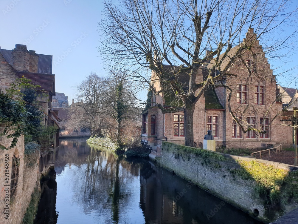 Fototapeta premium Classic panoramic view of the historic city center of Bruges (Brugge), West Flanders province, Belgium. Cityscape of Bruges with canal. Brugge streets and historic centre of medieval historic city.