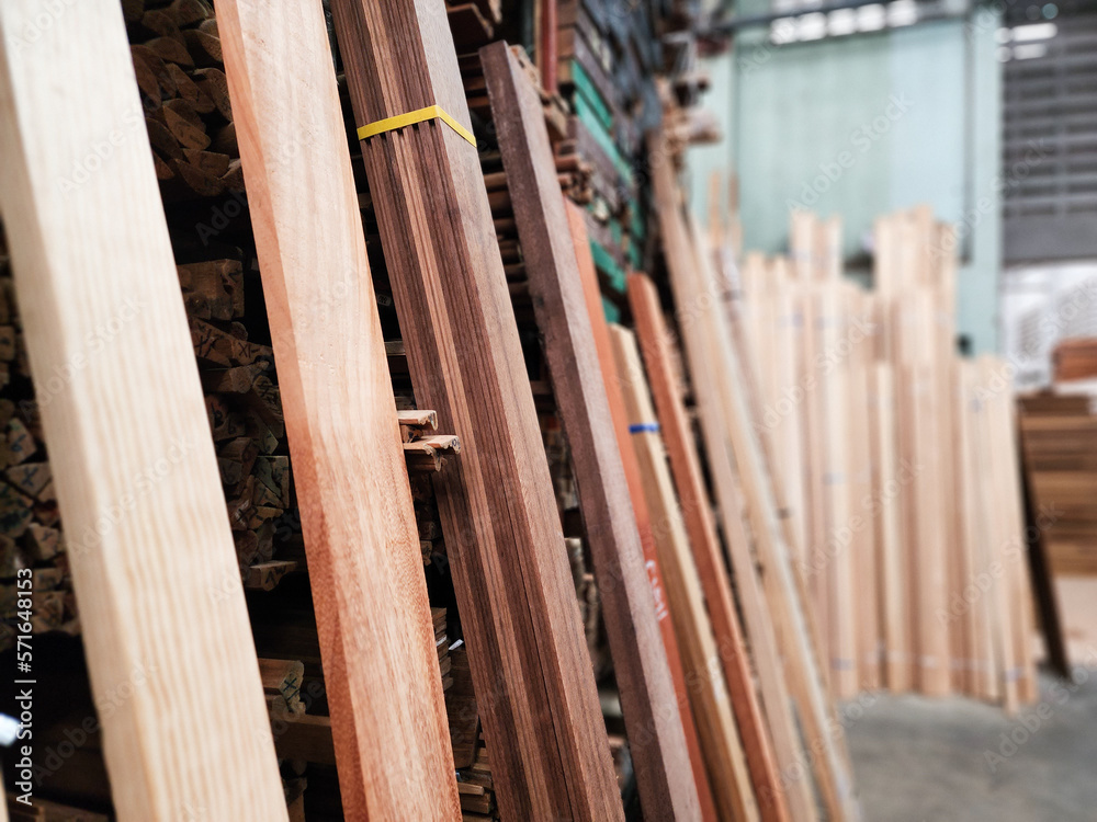Teak wood,teak wood stump in the sawmill on low light indoor,Piles of