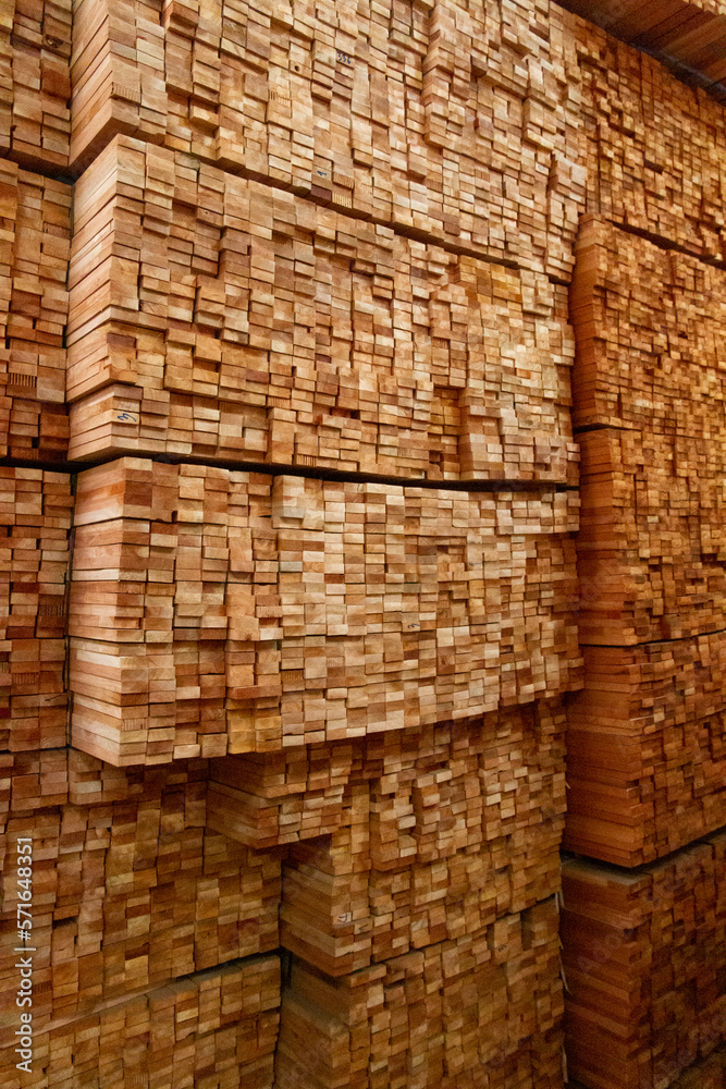 Teak wood,teak wood stump in the sawmill on low light indoor,Piles of teak wood neatly arranged