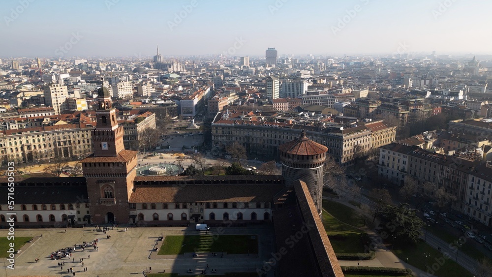 EUROPE, ITALY MILAN 2023 - Drone aerial view  from Sforza Castle in Sempione park with skyline of the city in downtown - Via Dante and Duomo cathedral 