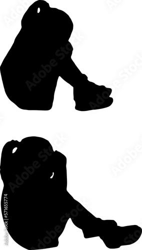 Silhouette of sad little girl sitting on a hill. Conceptual image