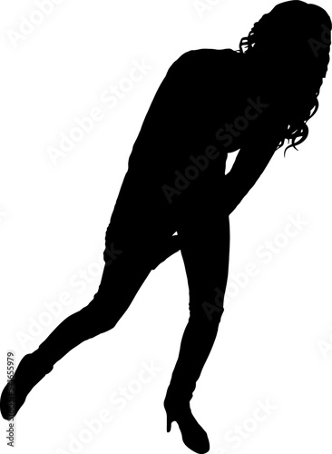 A woman with pain in her leg holds on to her injured leg while limping. The concept of pain and injury in the leg