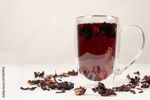Red hibiscus tea from the petals of the Sudanese rose in a glass cup with a double bottom