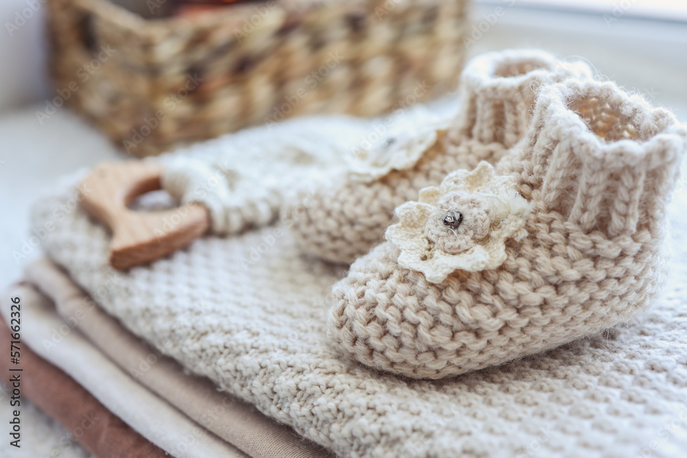 Knitted socks and a toy for a newborn handmade close-up Knitted socks and a toy for a newborn handmade close-up