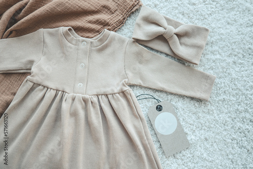 Cute baby beige dress with craft tag, space for your logo
