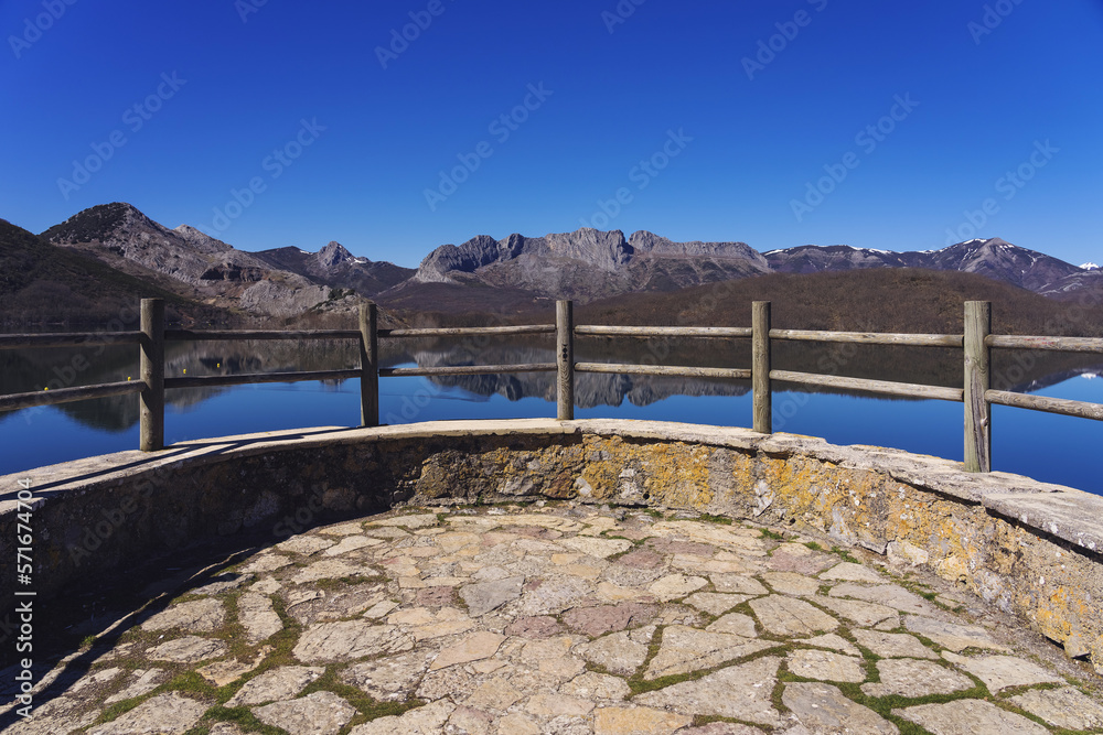 Viewpoint of the porma reservoir, in the province of leon, on a sunny day with the mountains reflected in the water of the reservoir. Castilla y Leon, Spain.