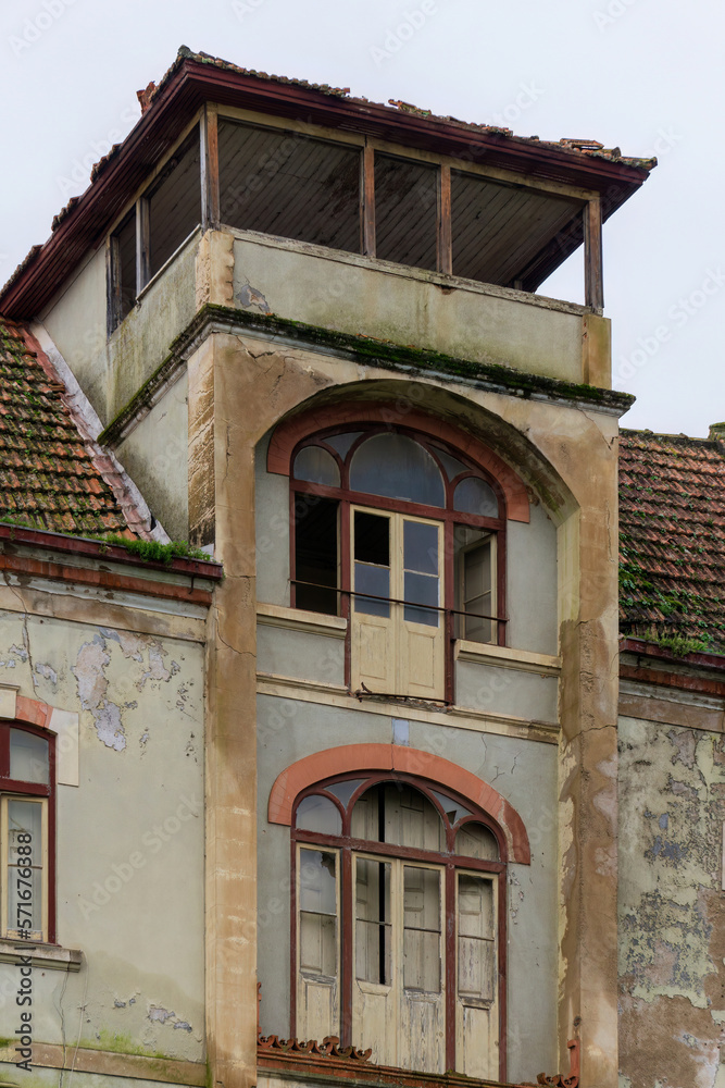 Antique abandoned multi-storey house with tile roof