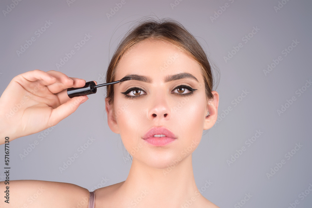 Beautiful woman with perfect shape eyebrows. Womans brows close up. Beautiful girl with eyebrow brush. Eyebrow correction. Long eyelashes and thick eyebrows.