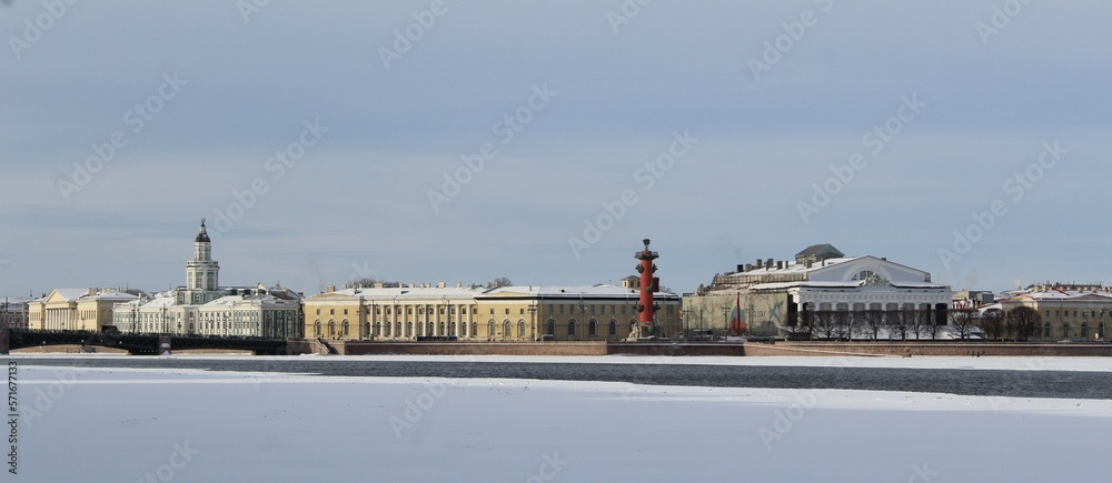 Fototapeta premium Beautiful winter cityscape. Historic city center of St. Petersburg, Russia. View of the building of the Kunstkamera. Ice floes on the Neva River.