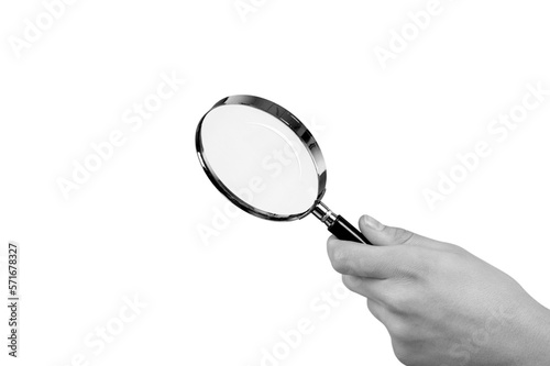 Human hand holding classic magnifying glass