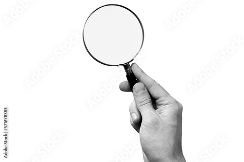 Human hand holding classic magnifying glass