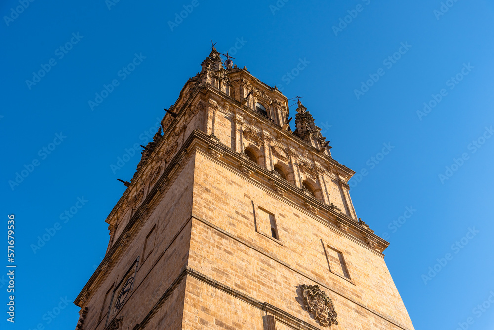 The tower of the Old Cathedral of Salamanca against blue sky during golden hour