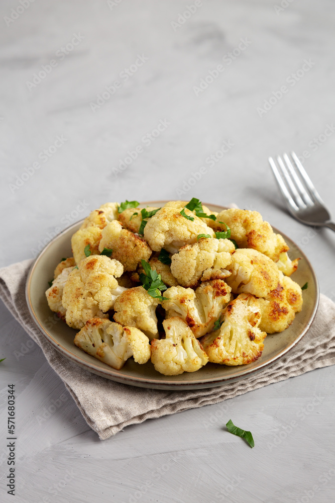 Homemade Roasted White Cauliflower on a Plate, side view. Copy space. Homemade Roasted White Cauliflower on a Plate, side view. Copy space.
