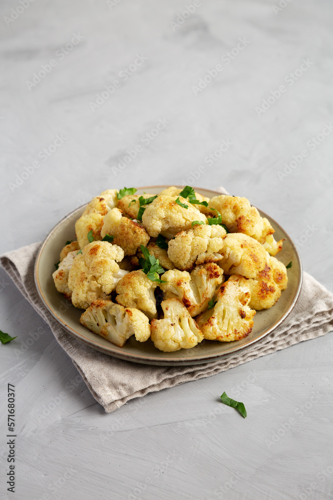 Homemade Roasted White Cauliflower on a Plate, side view. Homemade Roasted White Cauliflower on a Plate, side view.