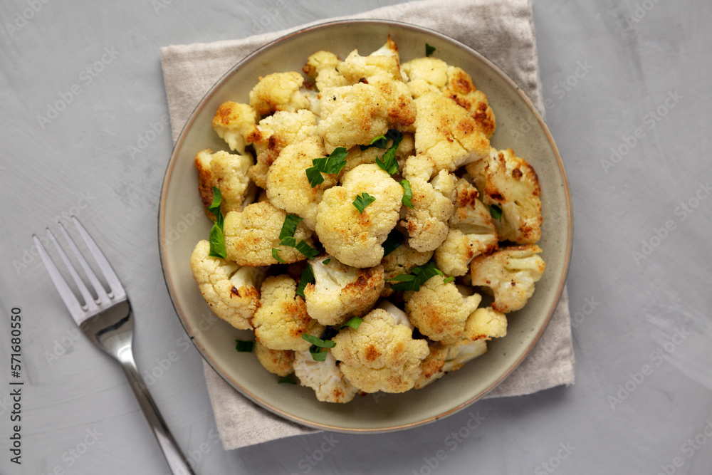 Homemade Roasted White Cauliflower on a Plate, top view. Flat lay, overhead, from above. Homemade Roasted White Cauliflower on a Plate, top view. Flat lay, overhead, from above.