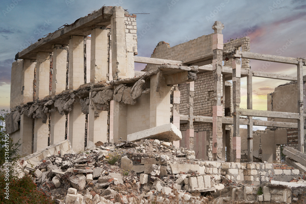 The frame of the destroyed building with a pile of debris of concrete and brick. Close-up. The frame of the destroyed building with a pile of debris of concrete and brick. Close-up.