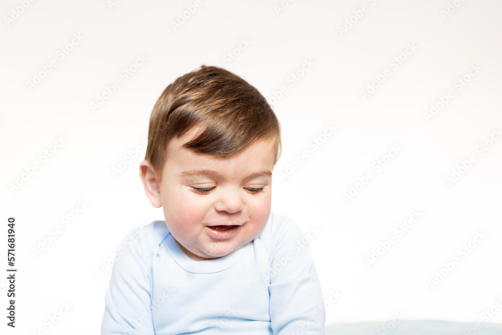 portrait of smiling eight month old baby, small 8 month old blond caucasian blond neonate on top of double bed portrait of smiling eight month old baby, small 8 month old blond caucasian blond neonate on top of double bed