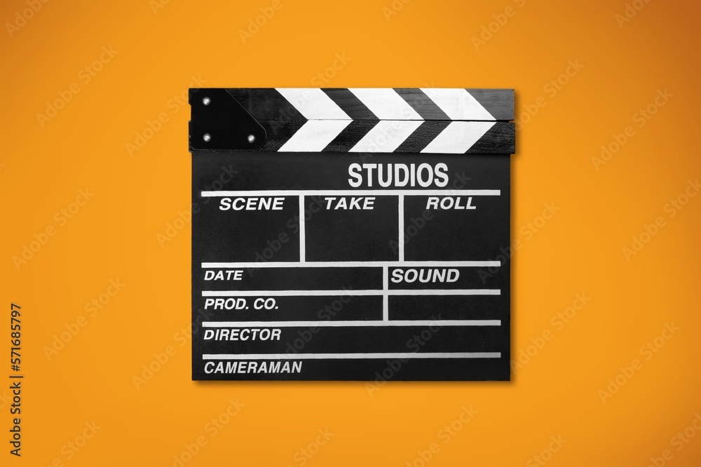 Classic movie clapperboard on colored desk