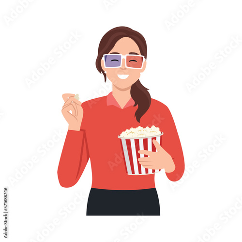 Young beautiful woman sitting in the auditorium and watching a 3D movie. A girl in 3D glasses sits in a red armchair and holds a container with popcorn