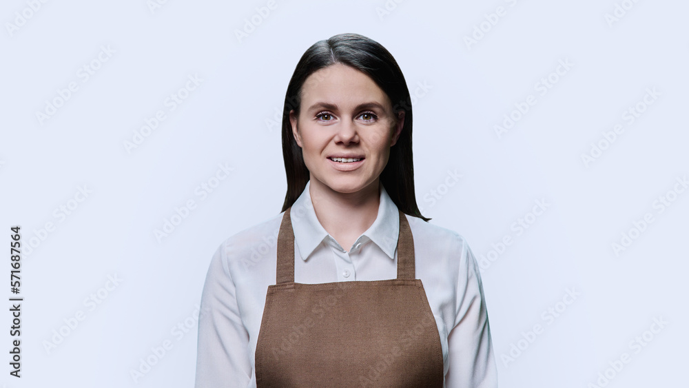Portrait of young woman in an apron on white background Portrait of young woman in an apron on white background