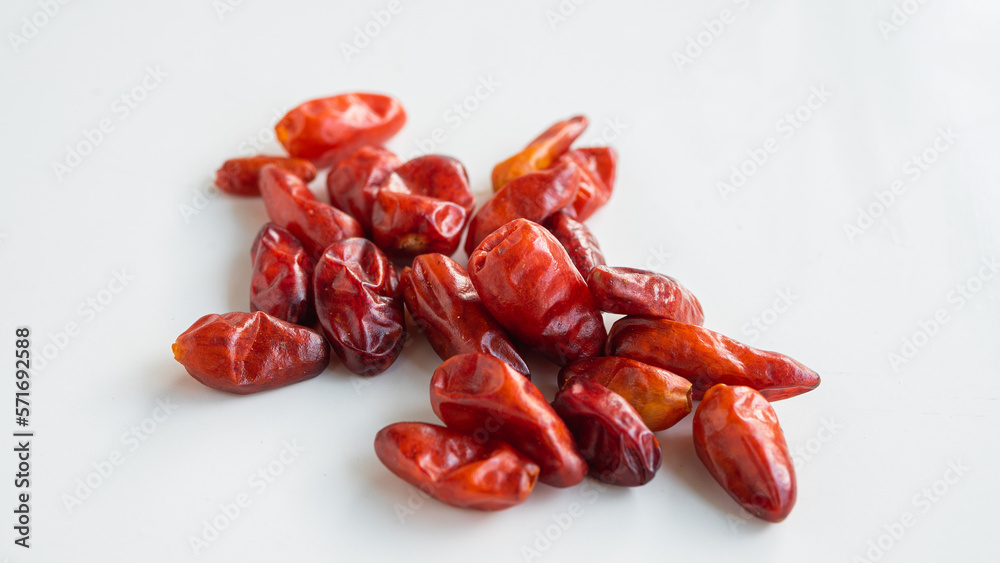 Close up of dried up pequin peppers on white background. Close up of dried up pequin peppers on white background.