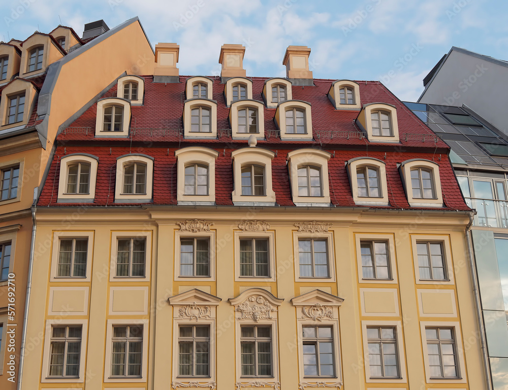 An impressive vintage house facade with windows as a geometric pattern and ceramic tiles roof, fully restored. Travel to Dresden, Saxony Germany.