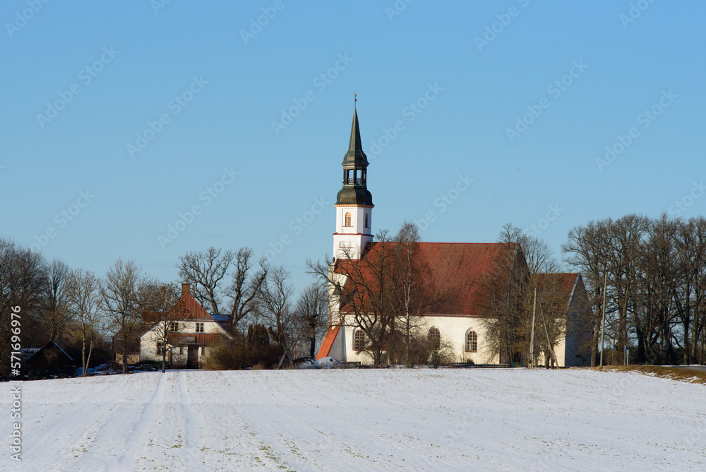a beautiful white church with a red roof in a sunny spring day