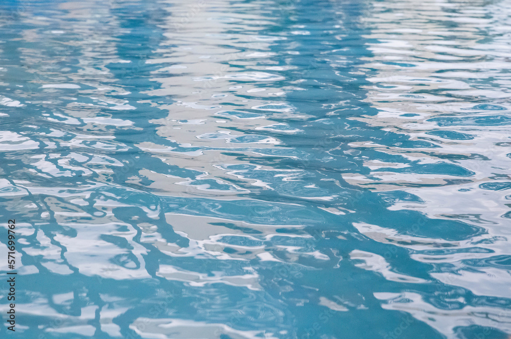 Blue wavy water in the pool. Background Blue wavy water in the pool. Background