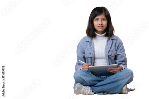 Mexican girl sitting on the floor with tablet and stylus pen