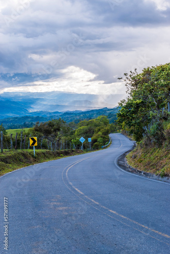 Beautiful asphalt road in the countryside. Landscape with long road in Colombia.