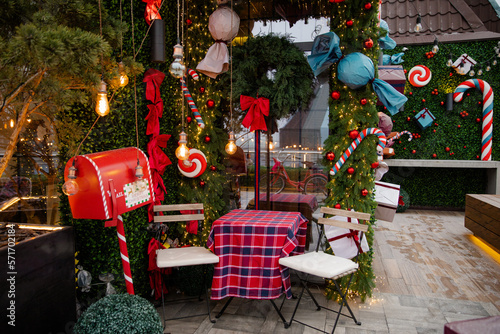 Christmas decorations. Cozy place on the terrace decorated for Christmas. Colorful Christmas decor with garlands