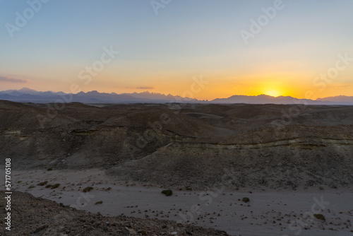 Sunset in the Hurghada desert, with the desert mountains on the horizon