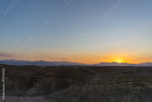 Sunset in the Hurghada desert, with the desert mountains on the horizon