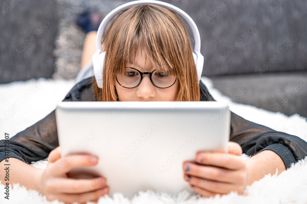 teenager with headphones and tablet on couch. children and modern technology, generation z teenager with headphones and tablet on couch. children and modern technology, generation z