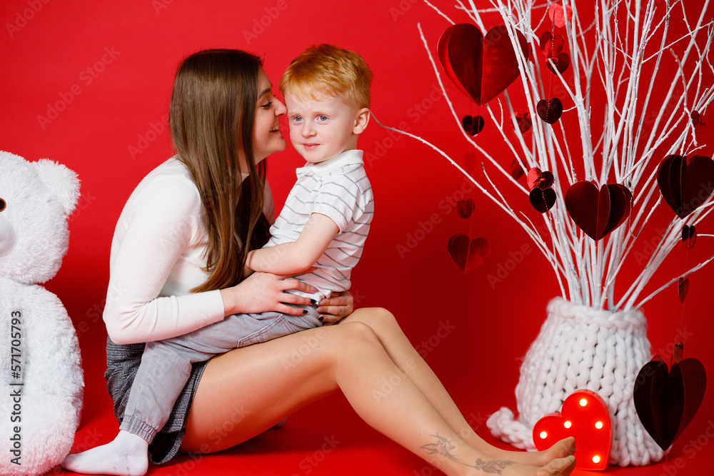 Obraz na płótnie 14.02.23. Vinnytsia, Ukraine: A brother and sister play at home. Red background. February 14 is Valentine's Day w salonie