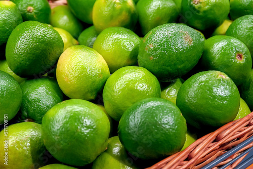 ripe juicy green limes lie on the counter in the store. healthy citrus fruits concept