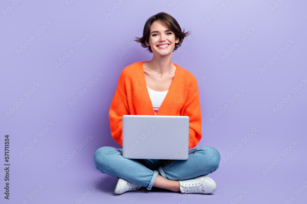 Full length size photo of young cheerful designer worker lady sitting use personal laptop enjoy her frelance job isolated on violet color background Full length size photo of young cheerful designer worker lady sitting use personal laptop enjoy her frelance job isolated on violet color background