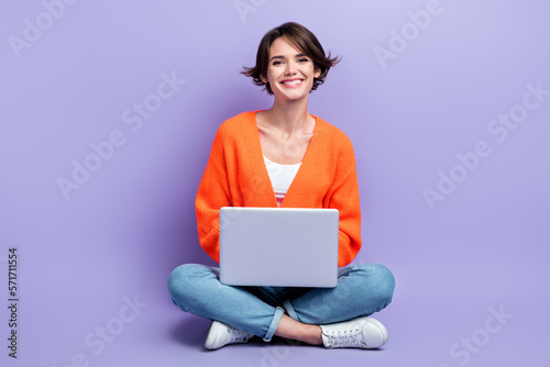 Full length size photo of young cheerful designer worker lady sitting use personal laptop enjoy her frelance job isolated on violet color background © deagreez