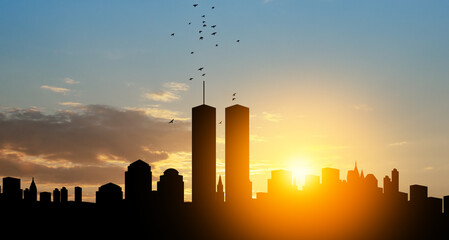 New York skyline silhouette with Twin Towers and birds flying up like souls at sunset. 09.11.2001 American Patriot Day banner.